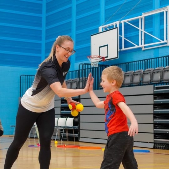 Oriam Kids, Tennis Classes, Coach and Child High-Five