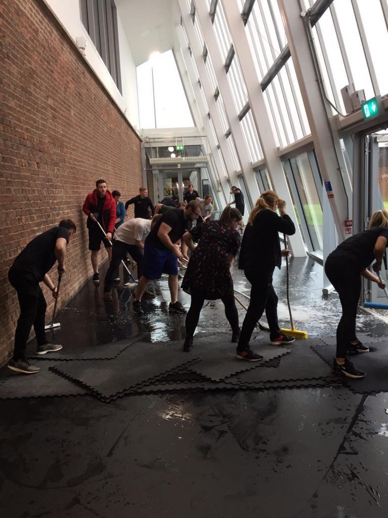 Oriam team support with cleaning following Oriam Hit With Flash Floods