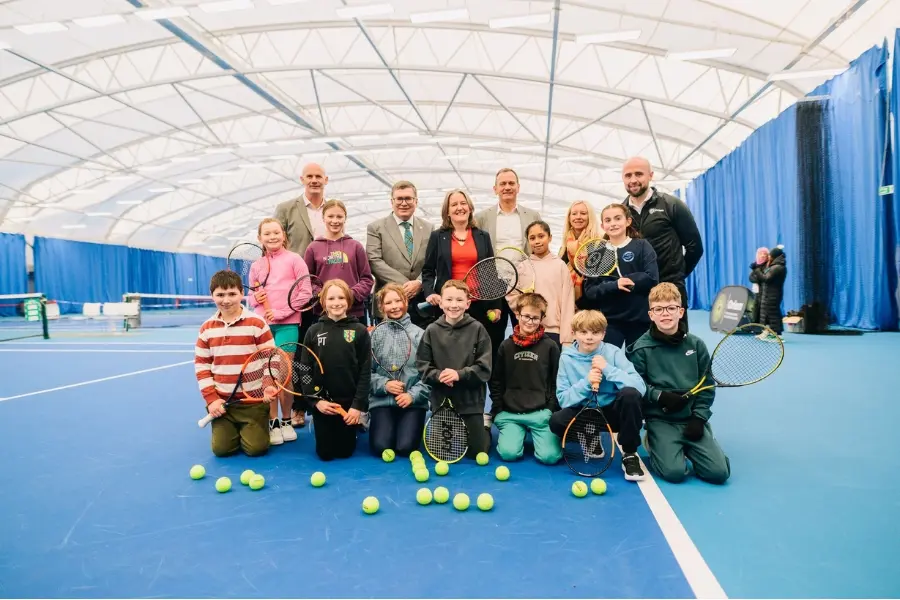 Local school children from Currie Primary School celebrate the opening of new indoor tennis centre with partners