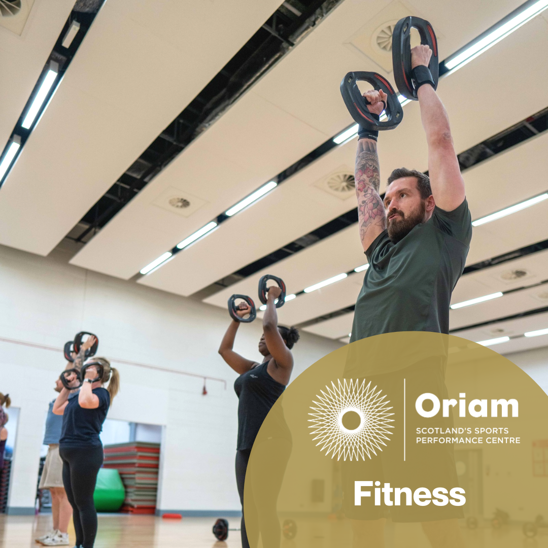 Oriam Fitness. Background image of 3 people in studio fitness class, working with small weights plates overhead. Foreground lower right corner, gold 1/2 circle with Oriam logo and 'Fitness' enclosed. 