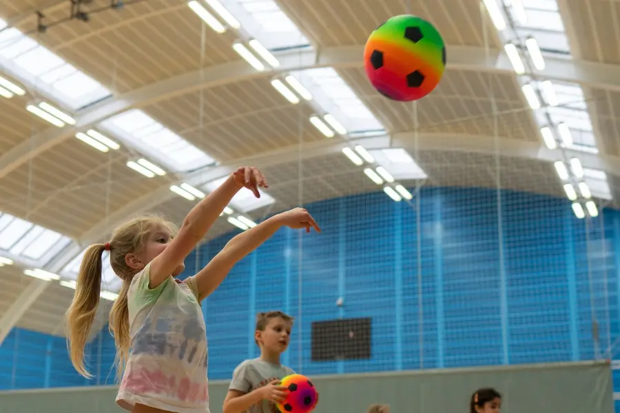 Child throwing colourful ball